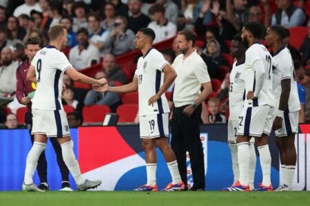 England coach Gareth Southgate looks on as Harry Kane shakes Trent Alexander-Arnold after he is substituted