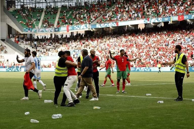 Achraf Hakimi reacts as pitch invaders cause havoc in Olympic football game between Argentina and Morocco