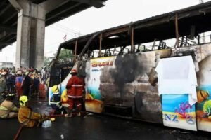 Burnt passenger bus and wreckage after a fatal collision on the Damascus-Deir Ezzor highway in Syria that killed 35 people.