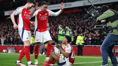 Arsenal's players celebrate with Myles Lewis-Skelly after his goal in the win over Man City at Emirates Stadium