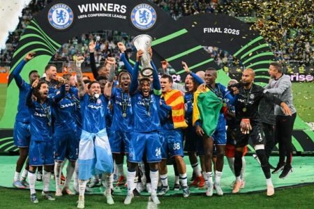 Chelsea captain Reece James lifts the UEFA Conference League trophy as his team celebrates their seventh European trophy