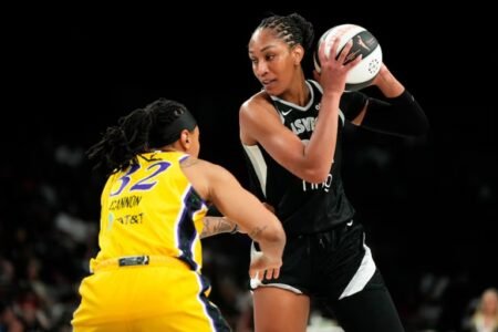 Aces’ A’ja Wilson exits in game with head injury Las Vegas Aces center A'ja Wilson (22) controls the ball against Los Angeles Sparks forward Emma Cannon (32) during the first half of a WNBA basketball game at Michelob Ultra Arena. Photo: Lucas Peltier-Imagn Images