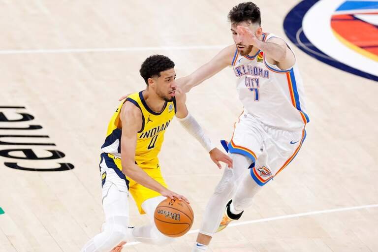 Indiana Pacers guard Tyrese Haliburton (0) drives to the basket past Oklahoma City Thunder forward Chet Holmgren (7) during the fourth quarter in game five of the 2025 NBA Finals at Paycom Center. Alonzo Adams-Imagn Images
