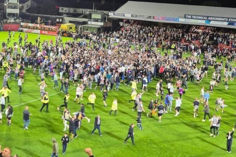 Grimsby fans flock field after kicking Man United out of Carabao Cup Grimsby fans flock field after kick Man United out of Carabao Cup