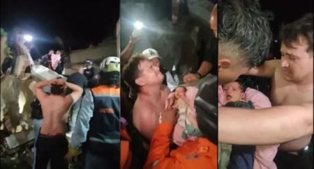 Rescue workers carry an 18-day-old baby to safety after pulling the infant from the rubble of a collapsed building in La Guaira following Venezuela's deadly earthquakes.