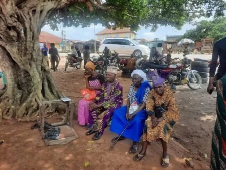 Elderly voters wait at a polling unit in Ekiti as officials attempt to complete BVAS biometric accreditation during the governorship election.