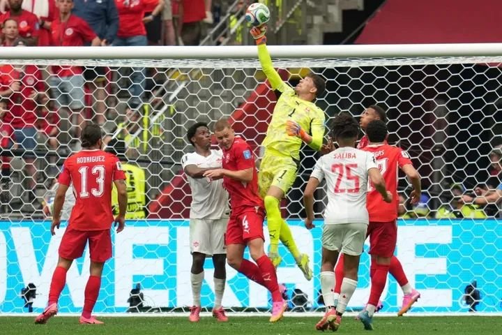 Switzerland goalkeeper Gregor Kobel leaping to block a shot during a World Cup Group B match against Canada in Vancouver