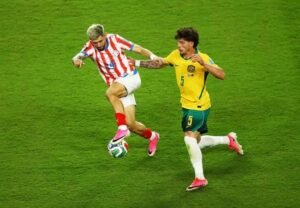 Australia's Jordan Bos challenges Paraguay's Julio Enciso during the goalless FIFA World Cup Group D match