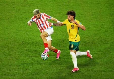 Australia's Jordan Bos challenges Paraguay's Julio Enciso during the goalless FIFA World Cup Group D match