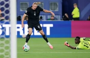 Norway's Erling Haaland shoots and scores as Senegal's Edouard Mendy looks on.