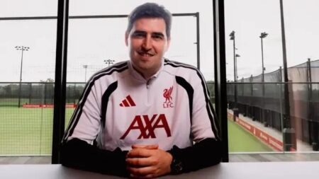 Andoni Iraola announced as Liverpool manager following departure from Arne Slot, posing in club-related setting.