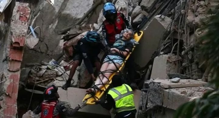 Rescue workers search through collapsed buildings in Caracas after twin earthquakes measuring 7.2 and 7.5 struck Venezuela, killing at least 32 people and injuring more than 700.