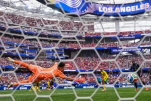 Canada's Stephen Eustaquio (7) scores their opening goal past South Africa goalkeeper Ronwen Williams (1) during the World Cup round of 32