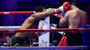 Anthony Joshua punches Kristian Prenga during their heavyweight fight, rallying from two first-round knockdowns to secure a second-round knockout victory and extend his record to 30-4.