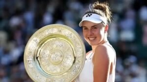 Linda Noskova poses with the Wimbledon women's singles trophy after defeating Karolina Muchova in the 2026 final.
