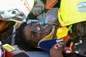 Rescuers carry Hernan Gil on a stretcher after he was pulled alive from a collapsed building in Catia La Mar, Venezuela, eight days after devastating earthquakes.