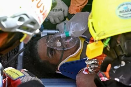 Rescuers carry Hernan Gil on a stretcher after he was pulled alive from a collapsed building in Catia La Mar, Venezuela, eight days after devastating earthquakes.