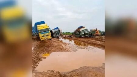 Heavy-duty trucks stuck in deep mud on the deteriorated Iruekpen–Ozalla–Sabo Road in Edo State